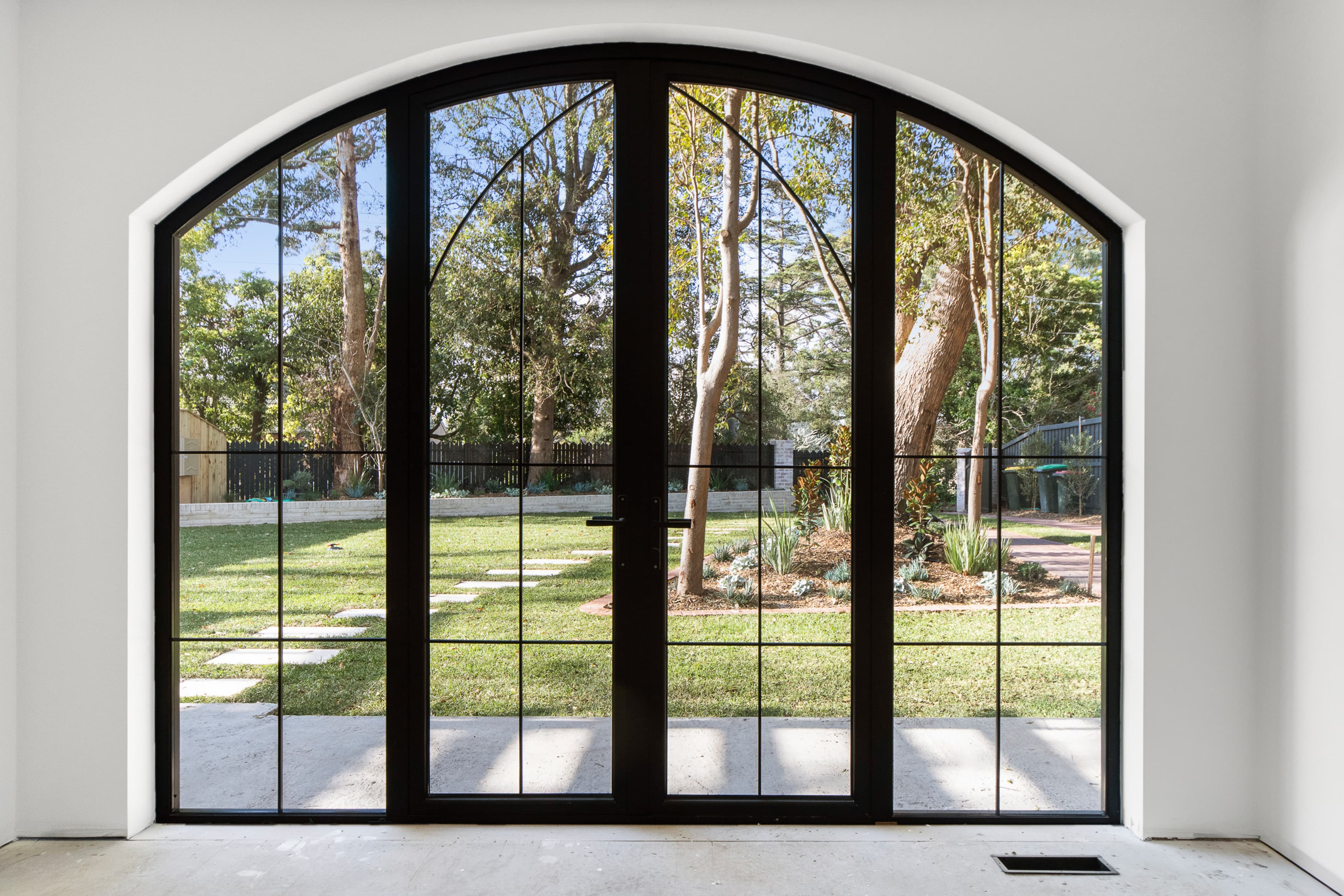 Installed arched black-framed door and window looking onto rear garden, Bembridge project