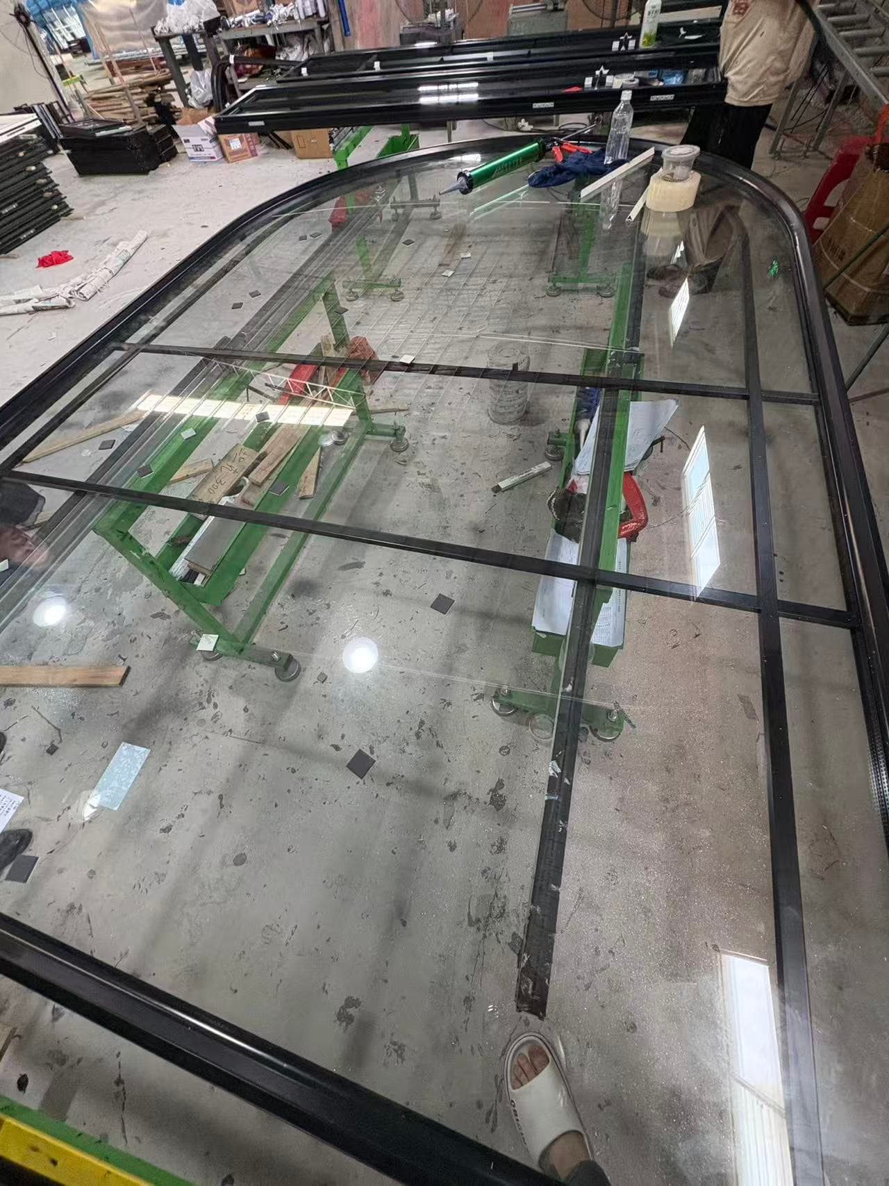 Custom arched skylight glazing unit being assembled at Chinese factory